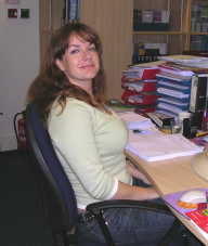 Jo at her
                desk
